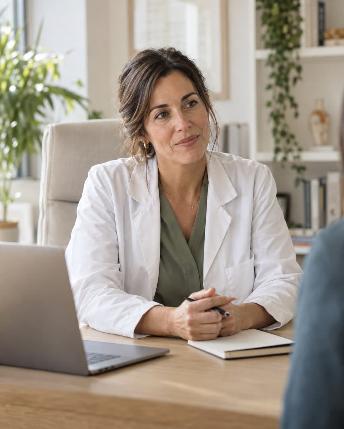 Escena ilustrativa de una médica conversando en una consulta luminosa